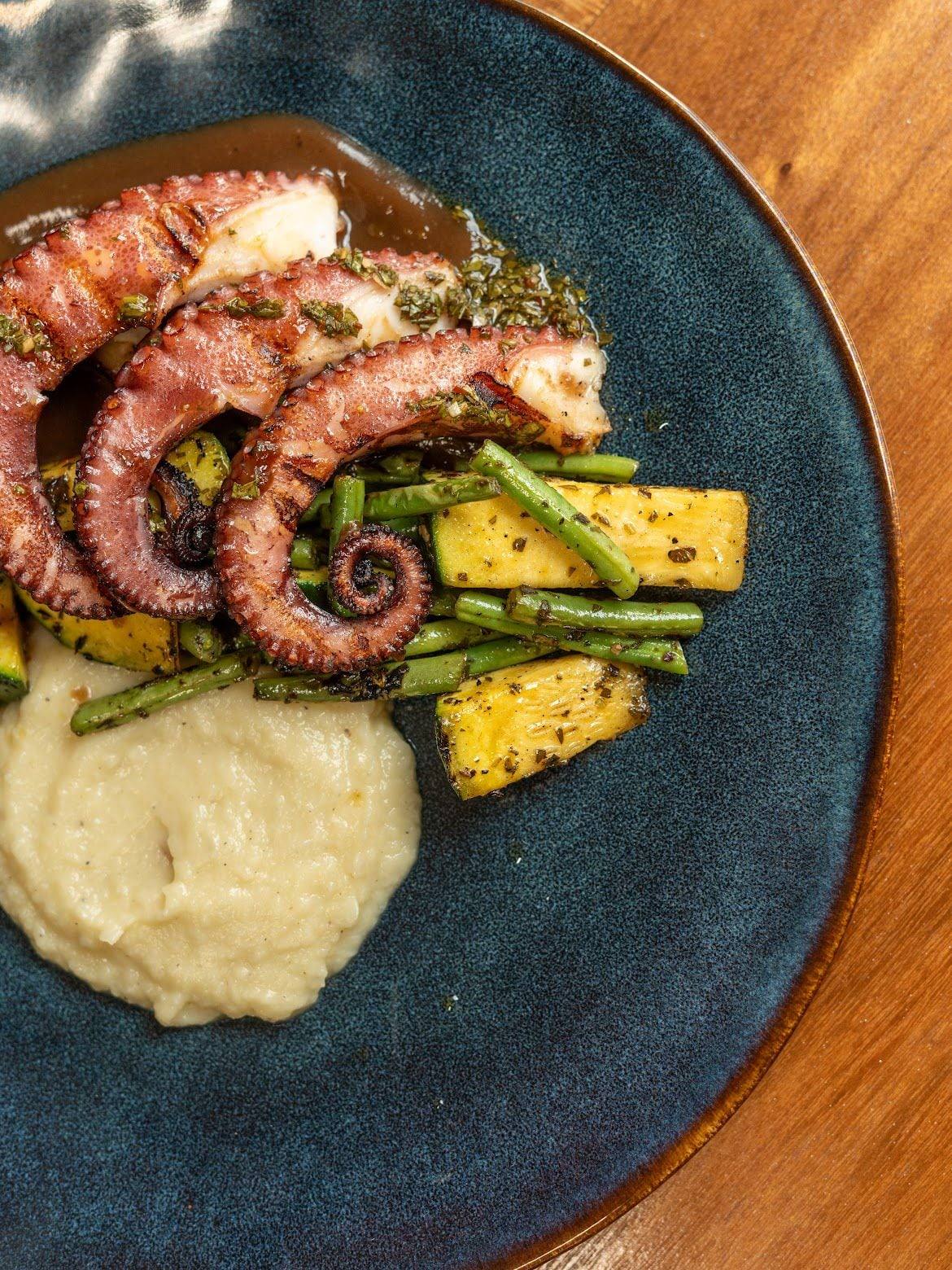 Grilled octopus with green beans, grilled zucchini and a silky purée